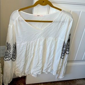 White with blue arm embellishments flowy blouse.